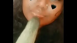Some ugly indian girl sucking a cucumber