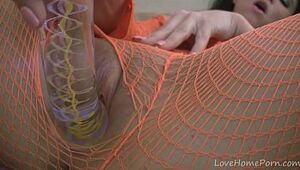 Horny sweetheart in fishnet lingerie masturbates with vigor